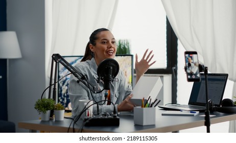 Digital Content Creator Unpacking And Reviewing Electronic Product To Audience. Famous Social Media Influencer Doing Promotional Video For Smartphone While Presenting It To Public In Home Studio.