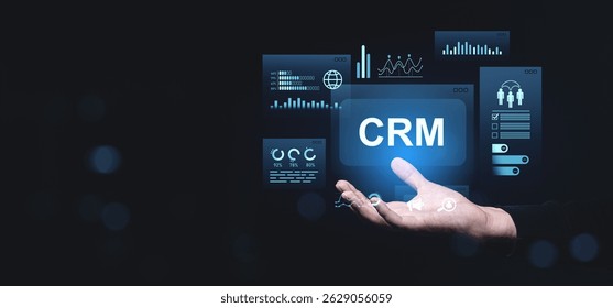Digital CRM interface with analytics, charts, user icons, and data graphs floating above a hand in futuristic style on dark background, concept of technology - Powered by Shutterstock - Get 15% off with code: PIKWIZARD15