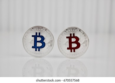 Digital currency physical silver bitcoin coin with blue and red sign.