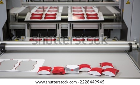 Digital cutting machine. Food folding packaging process on digital cutting machine. Printing industry.