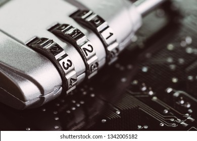 Digital cyber safety or security encryption concept, code numbers on combination pad lock on computer circuit board with solder, technology to encode online information or data protection.