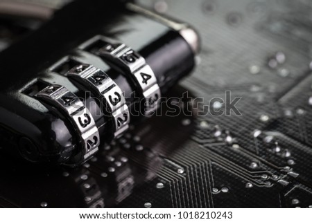 Digital cyber safety or security encryption concept, code numbers on combination pad lock on computer circuit board with solder, technology to encode online information or data protection.