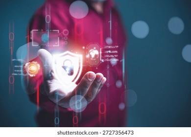 Digital data security shield protecting the network cybersecurity and data protection in a digital environment. A businessman holds a glowing shield icon, representing active network security.