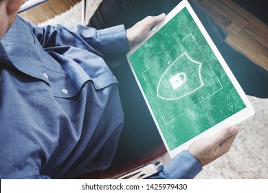 Digital data security system, and internet safety. a man using digital tablet and shielding lock icon on screen