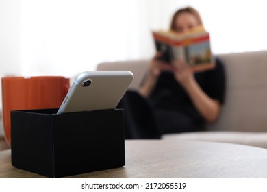 Digital Detox Concept Photo. Woman Rejecting Social Media Addiction Reading Book.