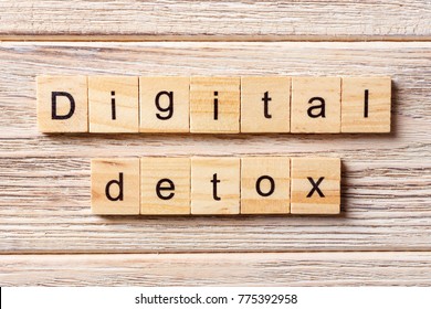 Digital Detox word written on wood block. Digital Detox text on table, concept.