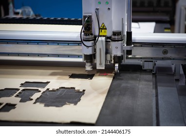 Digital die cutter machine cutting corrugated cardboard box for packaging. Industrial manufacture. - Shutterstock ID 2144406175