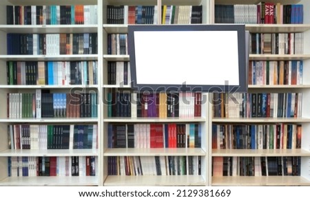 digital display in front of bookshelf