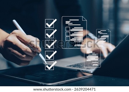 Digital document management and workflow automation: A hand uses a stylus on a tablet, with a laptop in the background, interacting with a holographic checklist and various digital document.