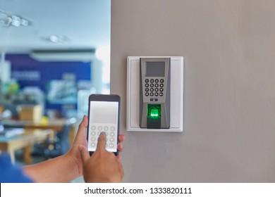 Digital door lock systems control by mobile phone for access security and protection. Man or woman user mobile for access digital door lock systems. Selective focus. - Shutterstock ID 1333820111