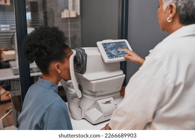 Digital eye test, vision and health for eyes, optometry and doctor with patient, eyecare and ophthalmology clinic. Machine, screen and black woman with senior optometrist, service and medical exam - Powered by Shutterstock