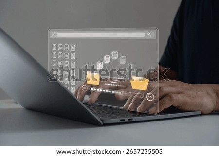 Digital File Data Transfer and Cloud Backup Concept for Business and Technology. Businessman using laptop to transfer files documents between digital folders with cloud storage online database system.