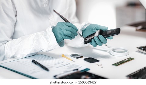 Digital Forensic Science. Police Forensic Analyst Examining Confiscated Mobile Phone.