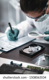 Digital Forensic Science. Police Forensic Analyst Examining Computer Hard Drive.