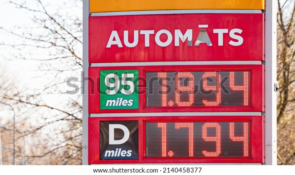 Digital fuel price board at a\
gas station showing increased prices for car fuel (gasoline) per\
liter.
