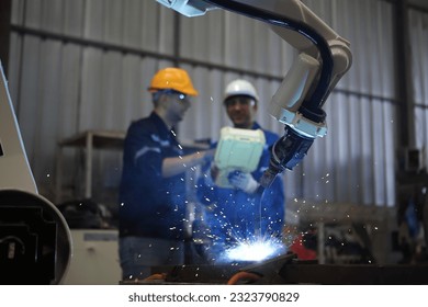 Digital future manufacture concept, Industrial Engineer working with automation robot arms machine  on real time monitoring system software. - Powered by Shutterstock - Get 15% off with code: PIKWIZARD15