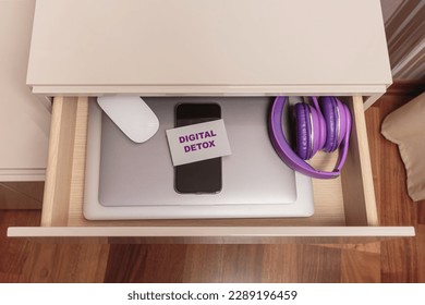 Digital gadget with inscription digital detox are in separate desk drawer. Stop using digital gadgets at home. Digital detox, technology and social media addiction concept