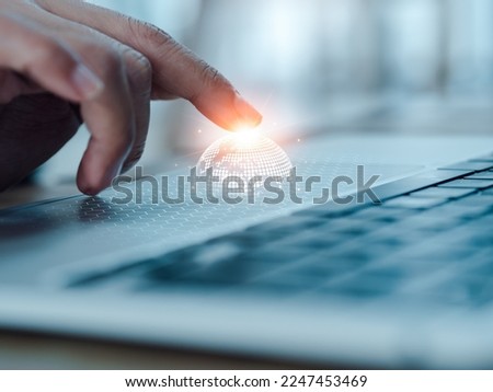 Digital global network technology expansion, business marketing and technology management concepts. Virtual digital earth on mesh appearing while fingertips touching on touchpad on laptop computer.