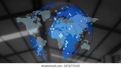 Digital globe displaying pixelated world map with blue and white dots. Blue background showing industrial setting with blurred structural elements, adding depth