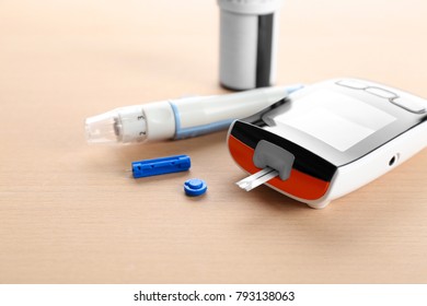 Digital Glucometer And Lancet Pen On Table. Diabetes Management