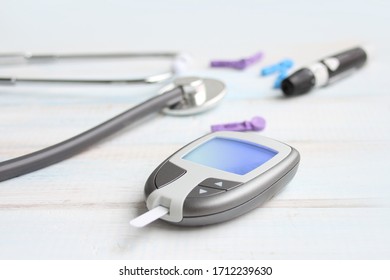 Digital Glucometer And Lancet Pen, Stethoscope, Blood In Vitro, On White Background, Concept Of Health, Medical Technology, Patient Monitoring