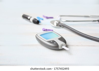 Digital Glucometer And Lancet Pen, Stethoscope, Blood In Vitro, On White Background, Concept Of Health, Medical Technology, Patient Monitoring