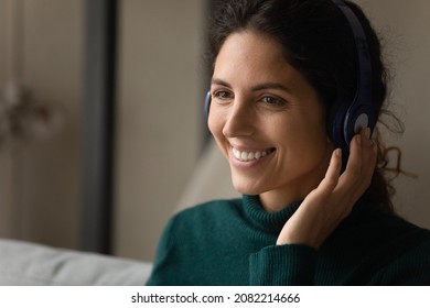 Digital Headphones. Close Up Shot Of Smiling Young Latina Woman Wearing Modern Wireless Earphones Talking To Customer Online By Video Call. Skilled Female Interpreter Translate Virtual Event Remotely