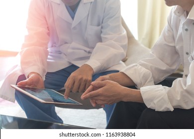 Digital Healthcare  Concepts. Doctor Physician Consulting With Patient Using New Technology Tablet To View Medical X-ray In Hospital.