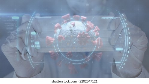 Digital Illustration Of A Scope Scanning, Finding A Macro Covid-19 Cell Over A Doctor Holding A Face Mas. Coronavirus Covid-19 Pandemic Concept Digitally Generated