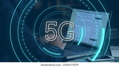 Digital image of futuristic circles moving around 5G with background of a hacker using a laptop - Powered by Shutterstock