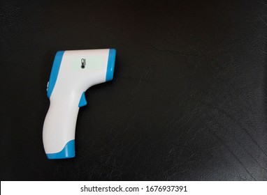 Digital Infrared Thermometer (thermometer Gun) For Check Forehead Temperature Measurement Screening From Coronavirus Disease 2019 (COVID-19). Black Background