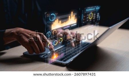 A digital interface shows data visualizations and analytics being interacted with on a laptop, highlighting technology and data analysis.