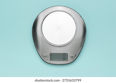 Digital Kitchen Scale on Light Blue Background for Accurate Weight Measurement