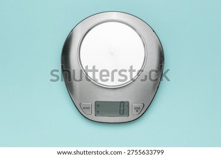 Digital Kitchen Scale on Light Blue Background for Accurate Weight Measurement