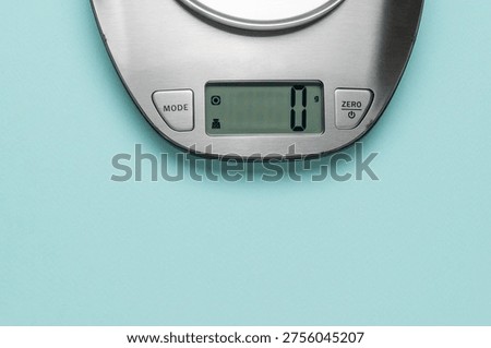 Digital Kitchen Scale on Light Blue Background Displaying Zero Grams