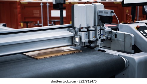 Digital laser die cut machine cutting corrugated cardboard. Industrial manufacture. - Powered by Shutterstock