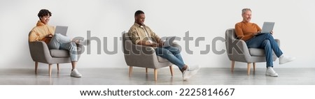 Digital Leisure. Diverse Multiethic Men Relaxing In Armchairs With Laptops, Creative Collage With Multicultural Males Of Different Age Sitting In Chairs And Using Computer For Pastime, Panorama