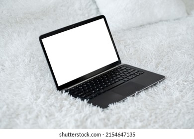 Digital Life. Computer Mockup. Online Connection. Opened Laptop With Blank Screen Laying Fluffy Bed Cover In Light Room Interior.