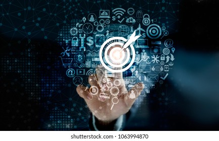 Digital marketing. Businessman touching darts aiming at the target center with icon network connection. Business goal and technology concept