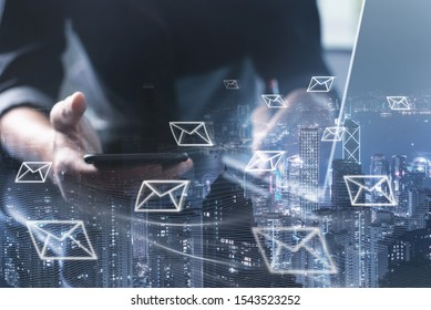 Digital marketing, Email campaign, newsletter, direct sales business strategy concept. Double exposure of business man sending email via smart phone, laptop computer and smart city with e-mail icons - Shutterstock ID 1543523252