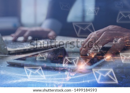 Digital marketing, Email campaign, newsletter, direct sales business strategy concept. Double exposure of business man sending email via digital tablet, laptop computer and smart city with e-mail icon
