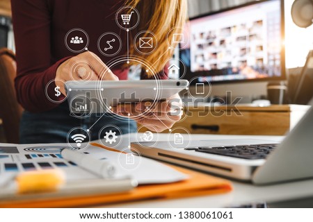Digital marketing media in virtual screen.business working digital tablet, smartphone with keyboard and computer laptop at office in morning light
