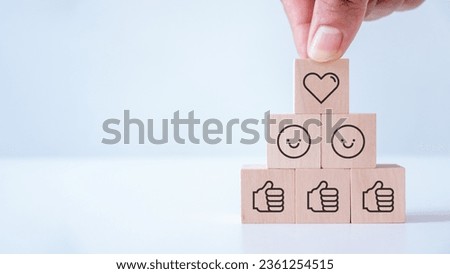 Digital marketing, Social media engagement concept. creating social media platforms to build relationships and drive sales. Sharing customer experiences. Placing the wooden cube blocks with emoticons.