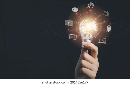 Digital marketing strategy idea concept. Content creator holding a bright light bulb great creative for target with virtual icon. - Shutterstock ID 2014356179