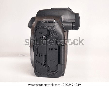 Digital mirrorless camera, side view of connectors. Microphone, headphones, HDMI, USB, remote control.