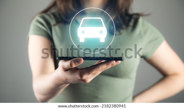 Digital mobility and mobile computing concept woman\
holding tablet with car\
model