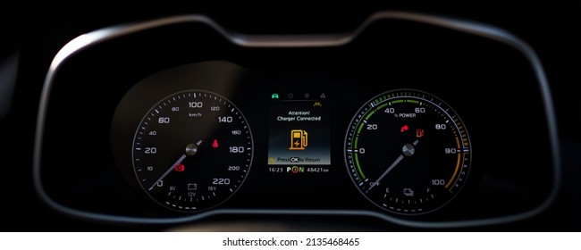 Digital Modern Dashboard In A Electric Vehicle - EV While Charging At The Charging Station, Battery Electric Vehicle Or BEV. Dashboard In The Vehicle Showing Charging Status.