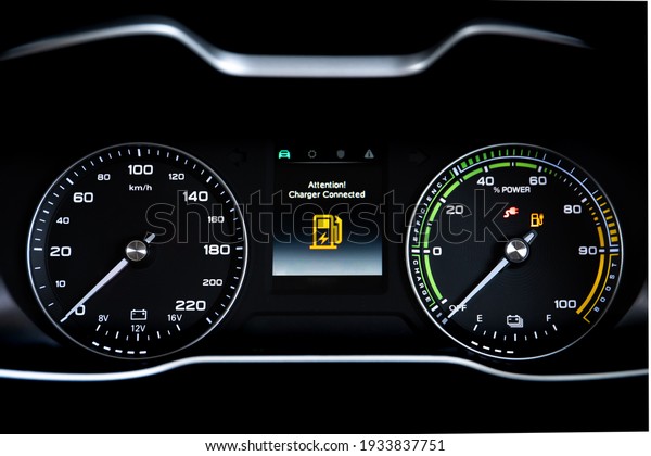 Digital modern dashboard\
in a electric vehicle - EV while charging at the charging station,\
battery electric vehicle or BEV. Dashboard in the vehicle showing\
charging status.