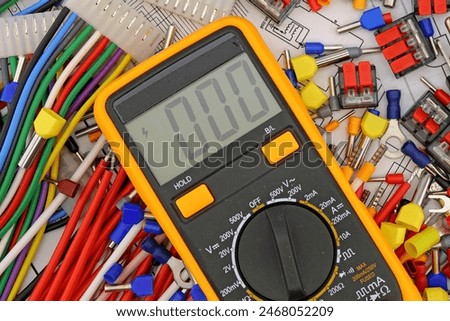 A digital multimeter for measuring the parameters of electrical circuits in an electrical diagram. Close-up.