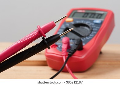 digital multimeter or multitester or Volt-Ohm meter (closeup at test leads), an electronic measuring instrument that combines several measurement functions in one unit.